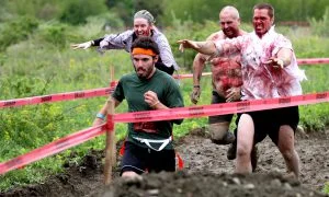 A runner tries to escape with his life as zombies pursue him during the Run for Your Lives race. The 5K course is littered with obstacles -- and the undead